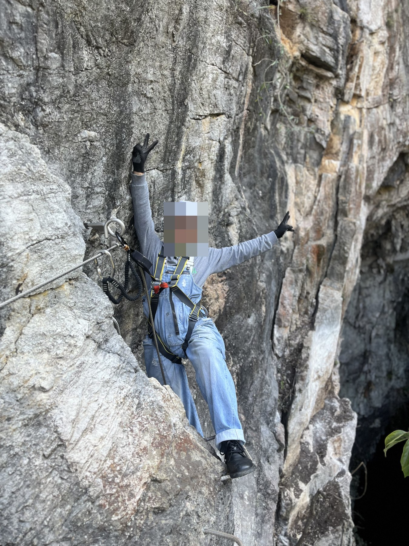 A helmeted climber between steep rock walls