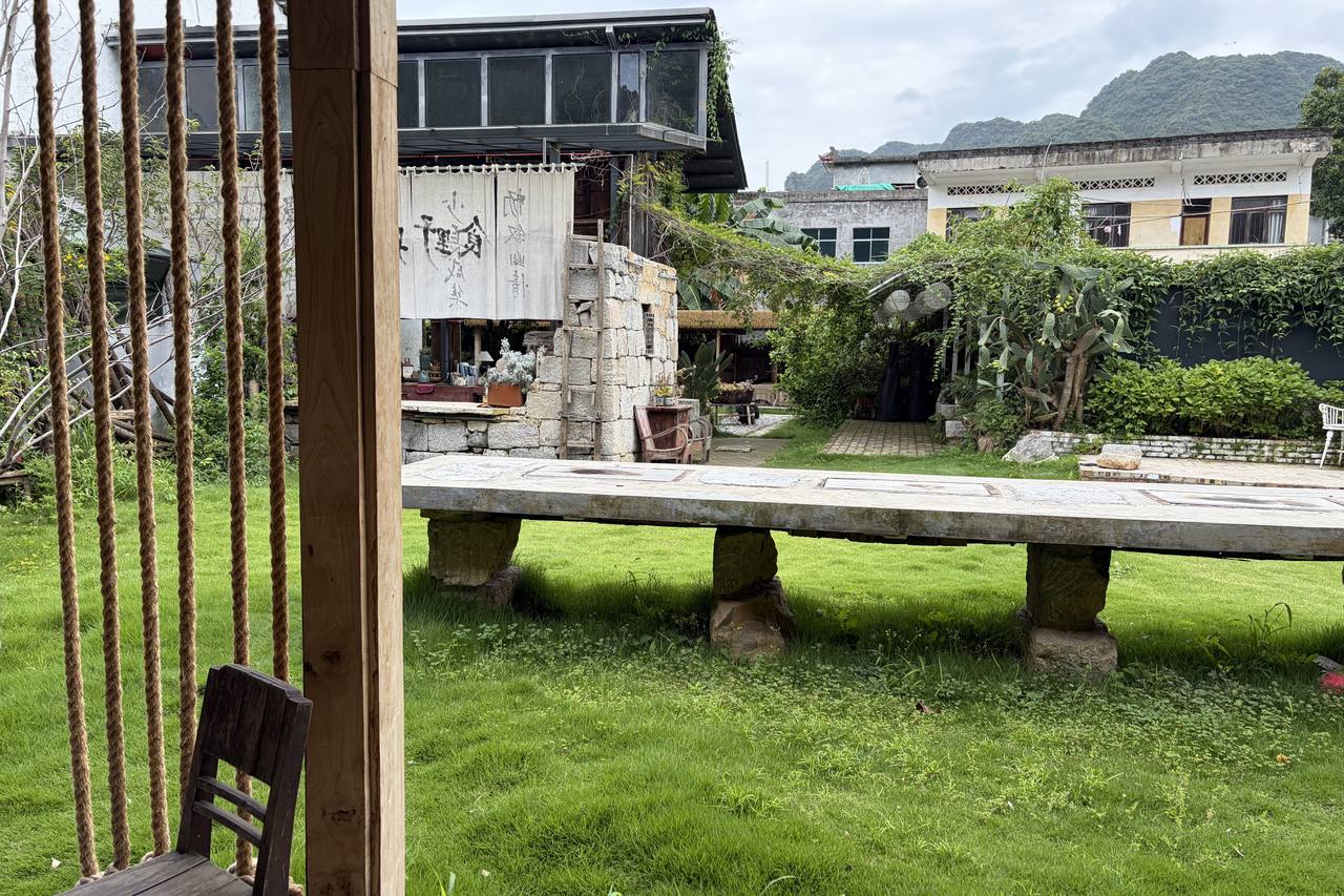 A family guesthouse courtyard in the Wanfenglin valley with peaks in the distance